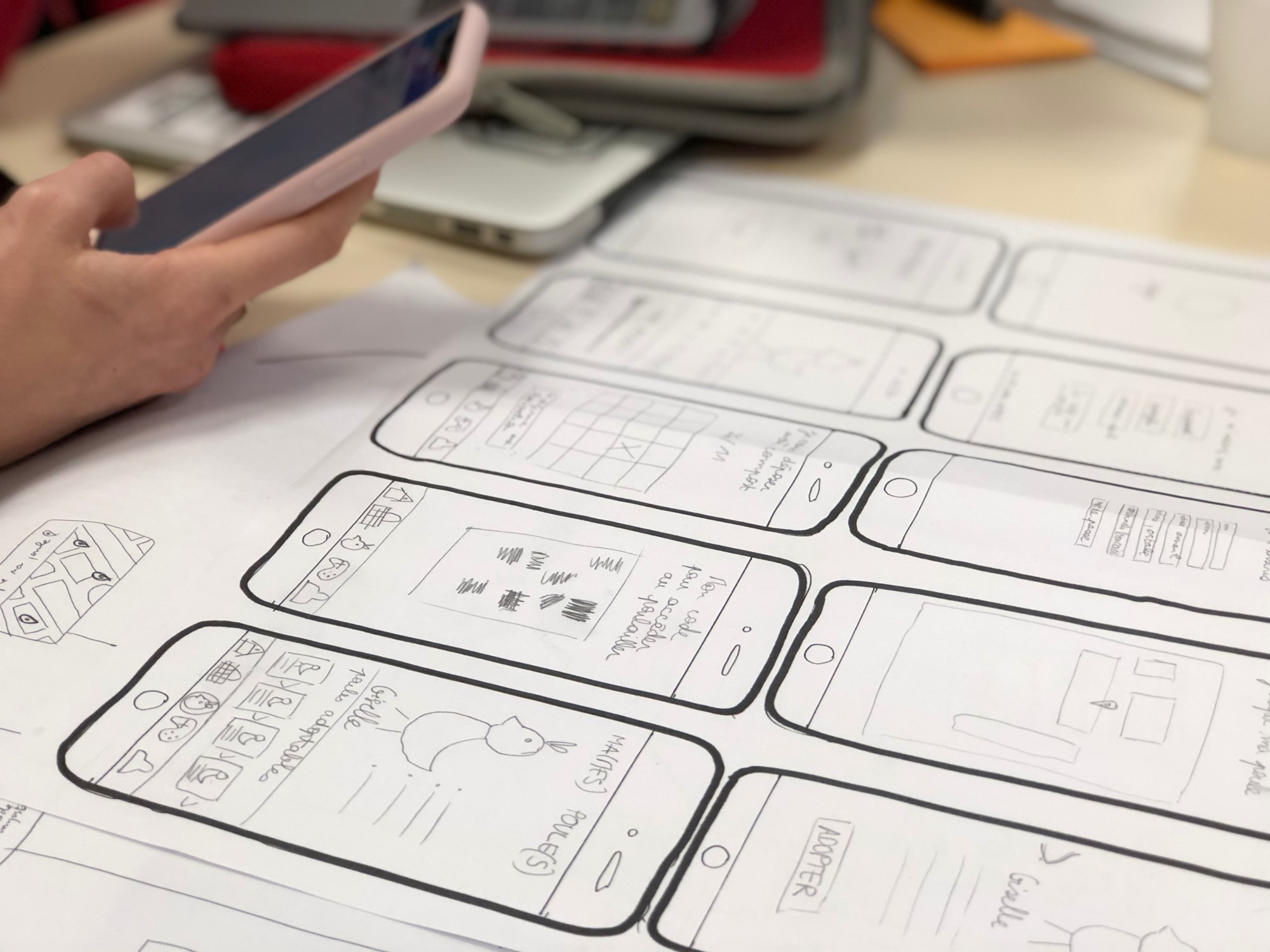 Designing mobile phone user interfaces using paper wireframes, and extentive paper prototypes.